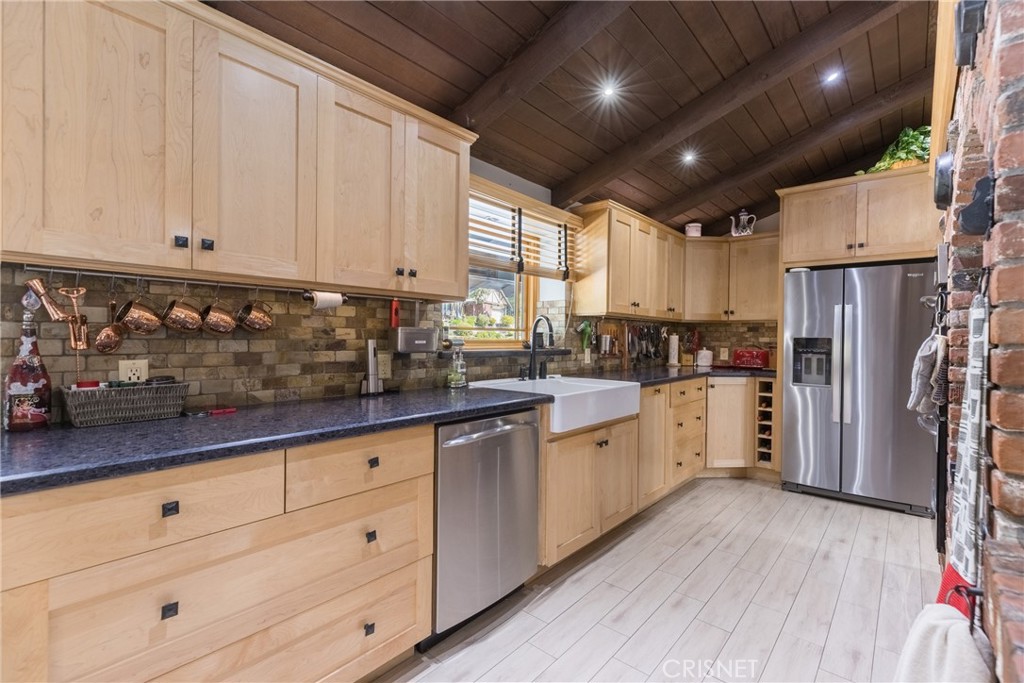 10610 Walnut Drive Shadow Hills, CA 91040 - Photo 6 of 50 a kitchen with granite countertop white cabinets and white appliances