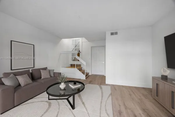 a living room with furniture and a flat screen tv