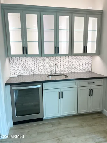 a kitchen with granite countertop a stove a sink and a window