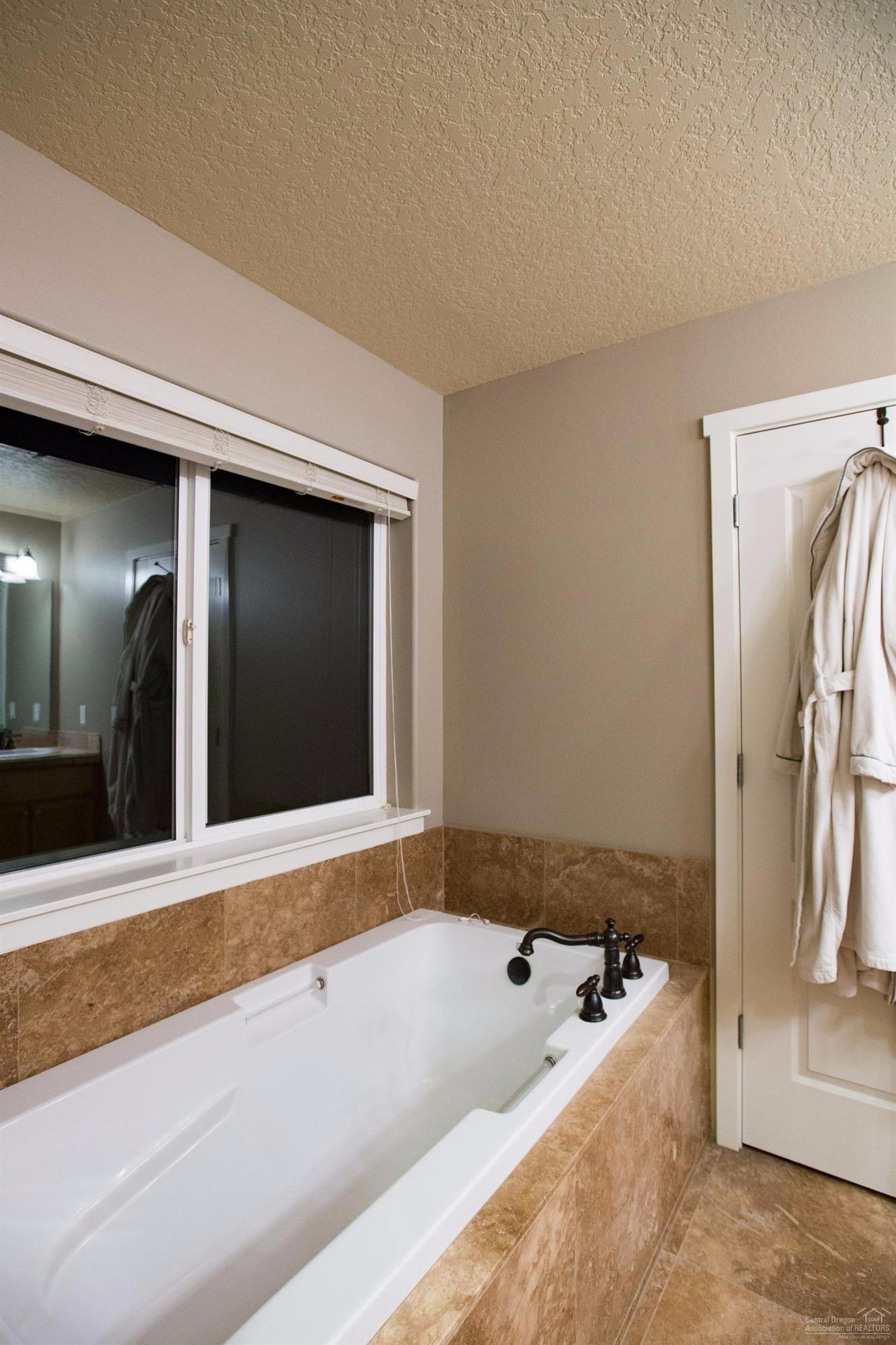 61468 Brosterhous Road Bend, OR 97702 - Photo 13 of 18 Relaxing soaking tub with tile surround.