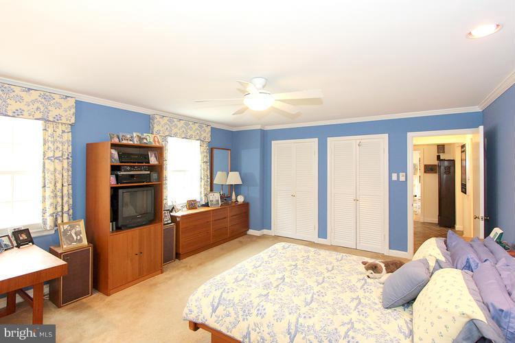 5922 Overlea Road Bethesda, MD 20816 - Photo 14 of 25 a bed room with a bed furniture and a flat screen tv