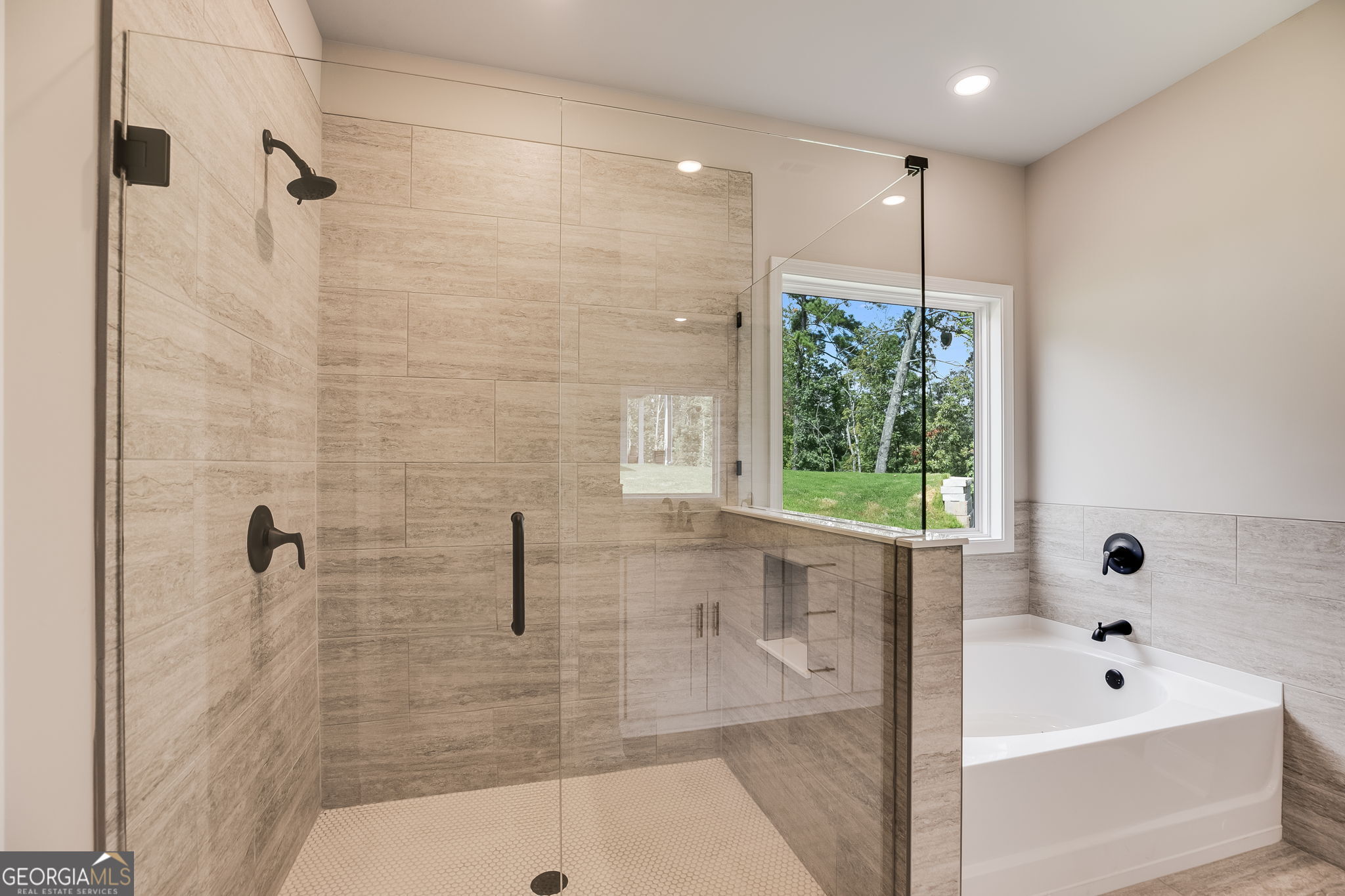 8970 Callaway Drive Winston, GA 30187 - Photo 18 of 24 a bathroom with a bathtub a window and a shower