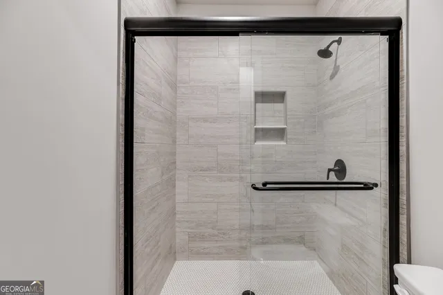 a bathroom with a shower and a sink