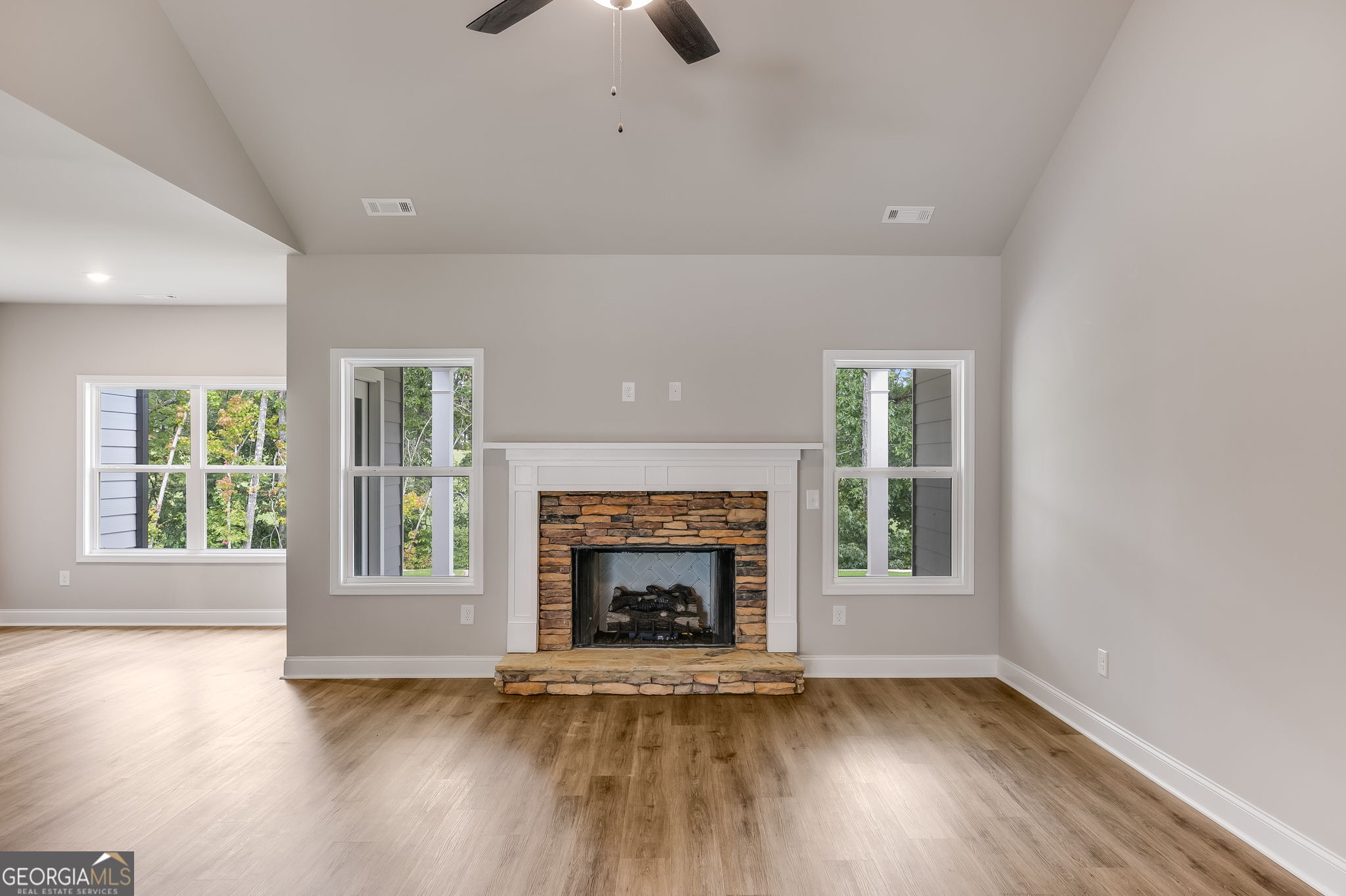 8970 Callaway Drive Winston, GA 30187 - Photo 5 of 24 an empty room with wooden floor fireplace and windows