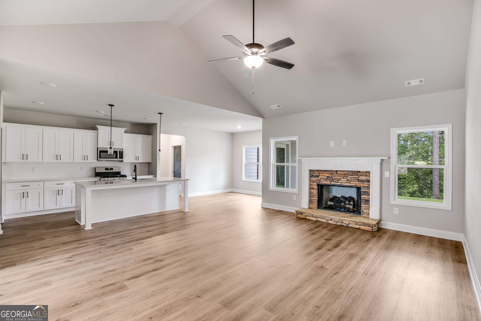 8970 Callaway Drive Winston, GA 30187 - Photo 6 of 24 a view of kitchen with microwave a stove and wooden floor