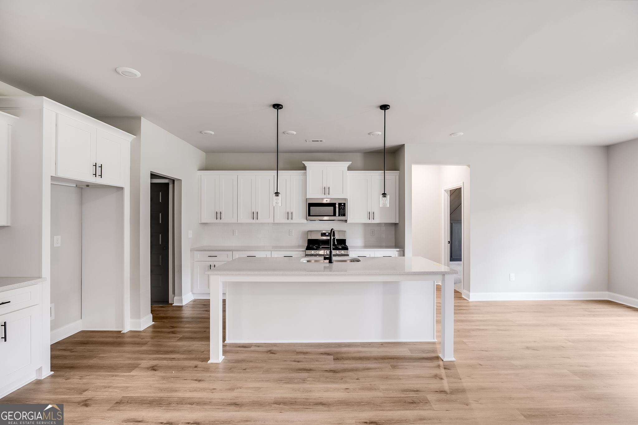 8970 Callaway Drive Winston, GA 30187 - Photo 7 of 24 a kitchen with kitchen island stainless steel appliances a refrigerator sink and cabinets