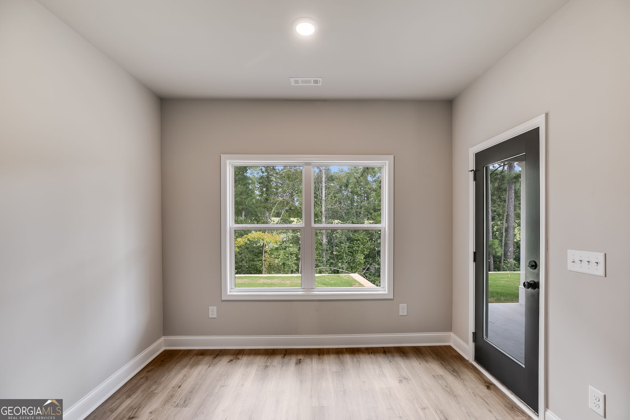 8970 Callaway Drive Winston, GA 30187 - Photo 8 of 24 an empty room with wooden floor and windows