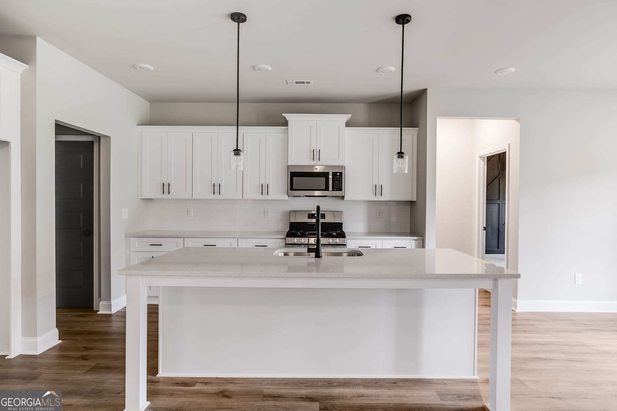 8970 Callaway Drive Winston, GA 30187 - Photo 10 of 24 a kitchen with kitchen island a counter top space appliances and cabinets