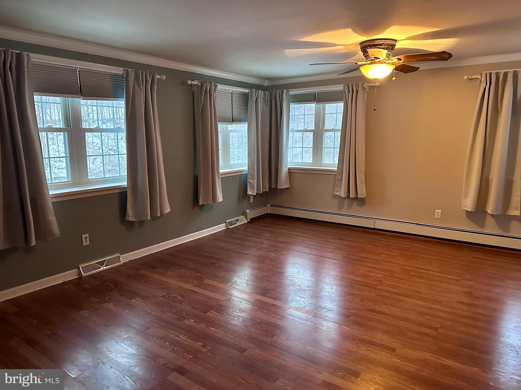707 Dunkels Church Road Kutztown, PA 19530 - Photo 24 of 37 an empty room with wooden floor and windows