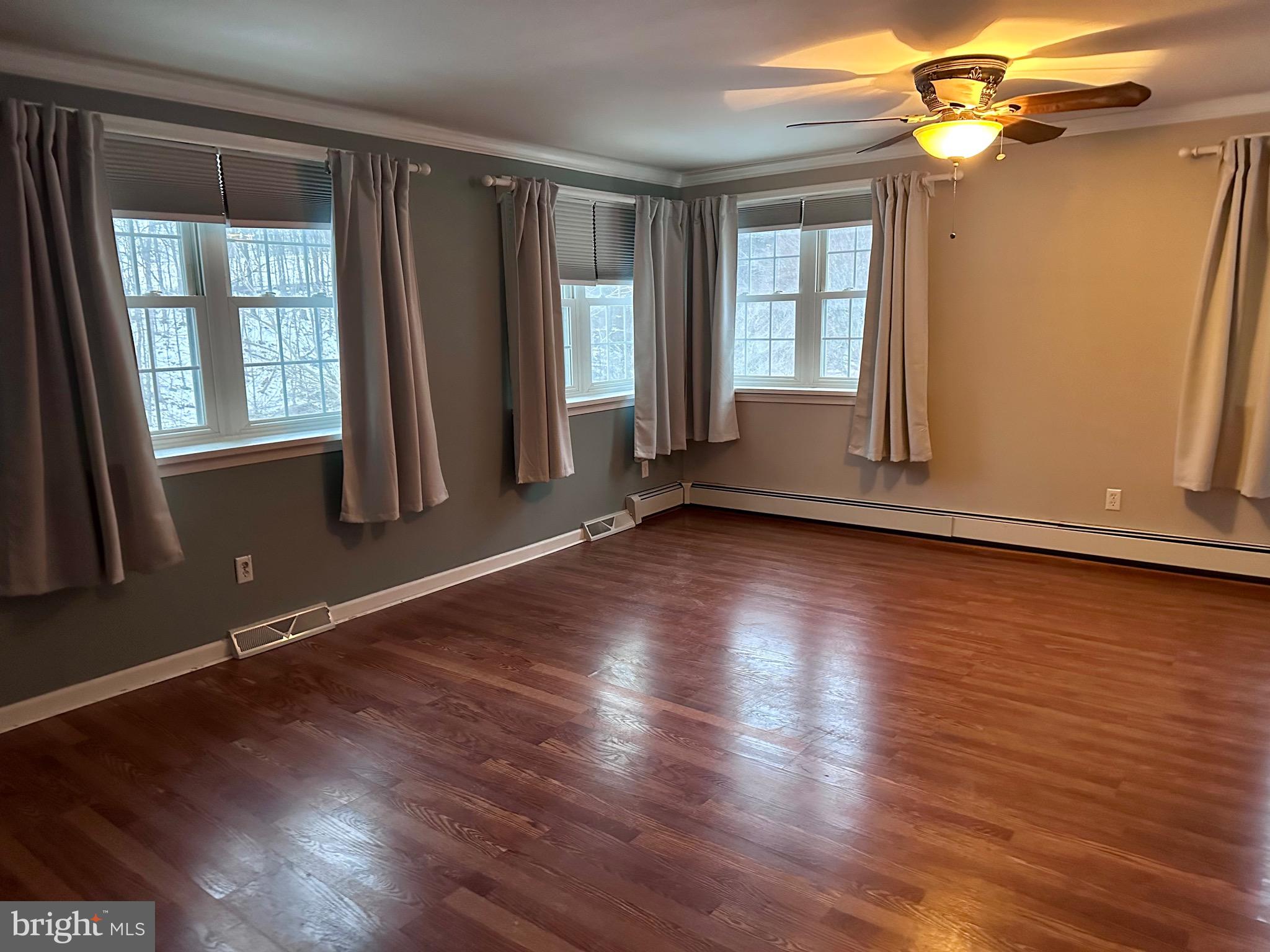 707 Dunkels Church Road Kutztown, PA 19530 - Photo 25 of 37 an empty room with wooden floor and windows