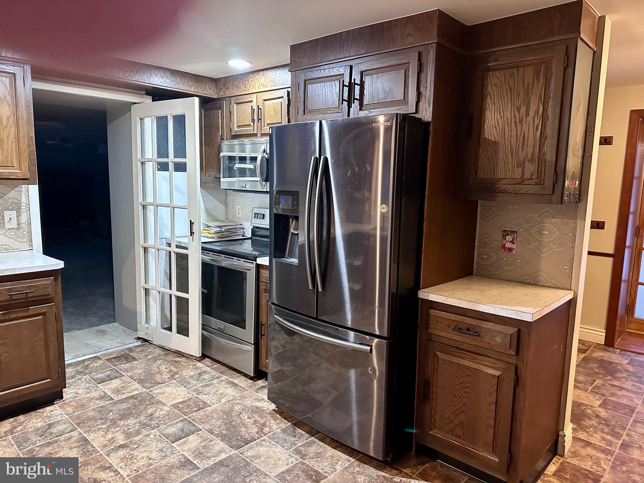 707 Dunkels Church Road Kutztown, PA 19530 - Photo 8 of 37 a kitchen with stainless steel appliances granite countertop a refrigerator stove and sink