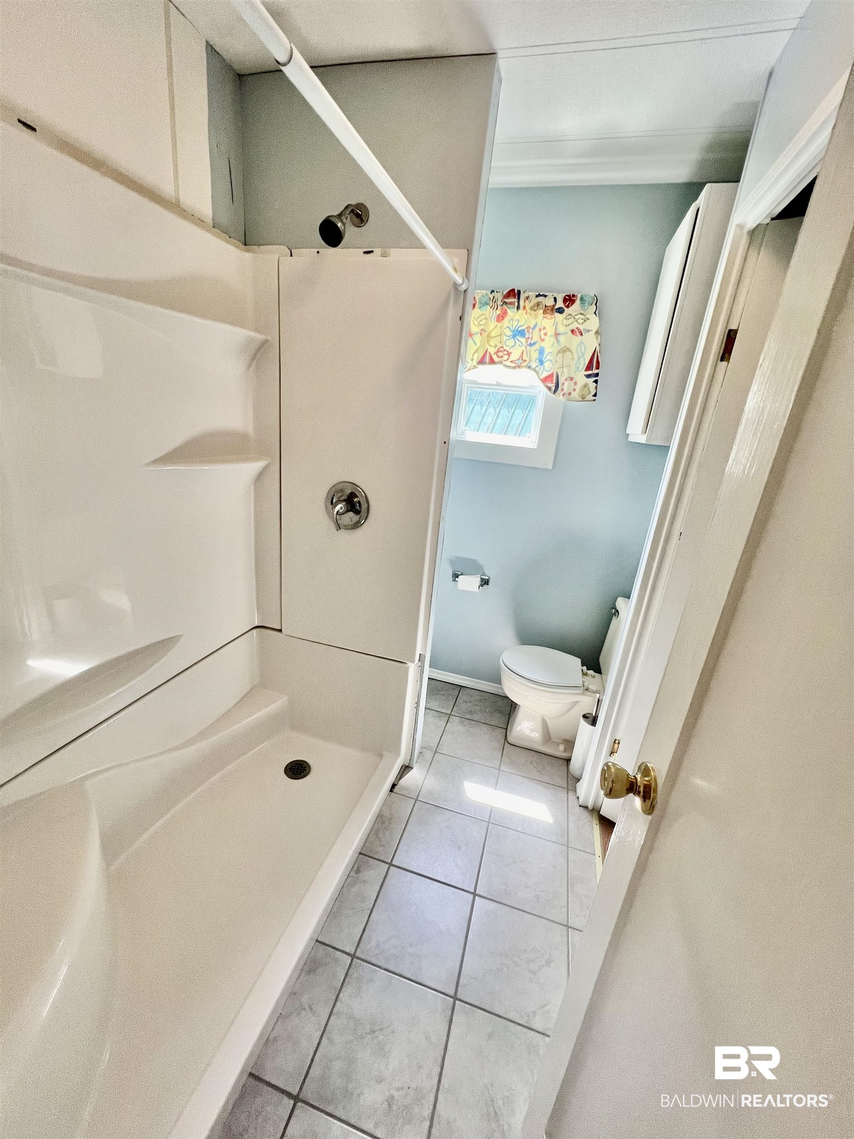 662 Escambia Loop Lillian, AL 36549 - Photo 15 of 26 Bathroom with tile patterned flooring, a shower, and toilet