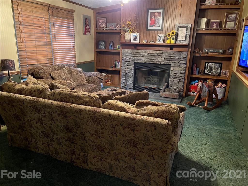141 Allen Loop Road Rutherfordton, NC 28139 - Photo 18 of 30 a living room with furniture a flat screen tv and a fireplace
