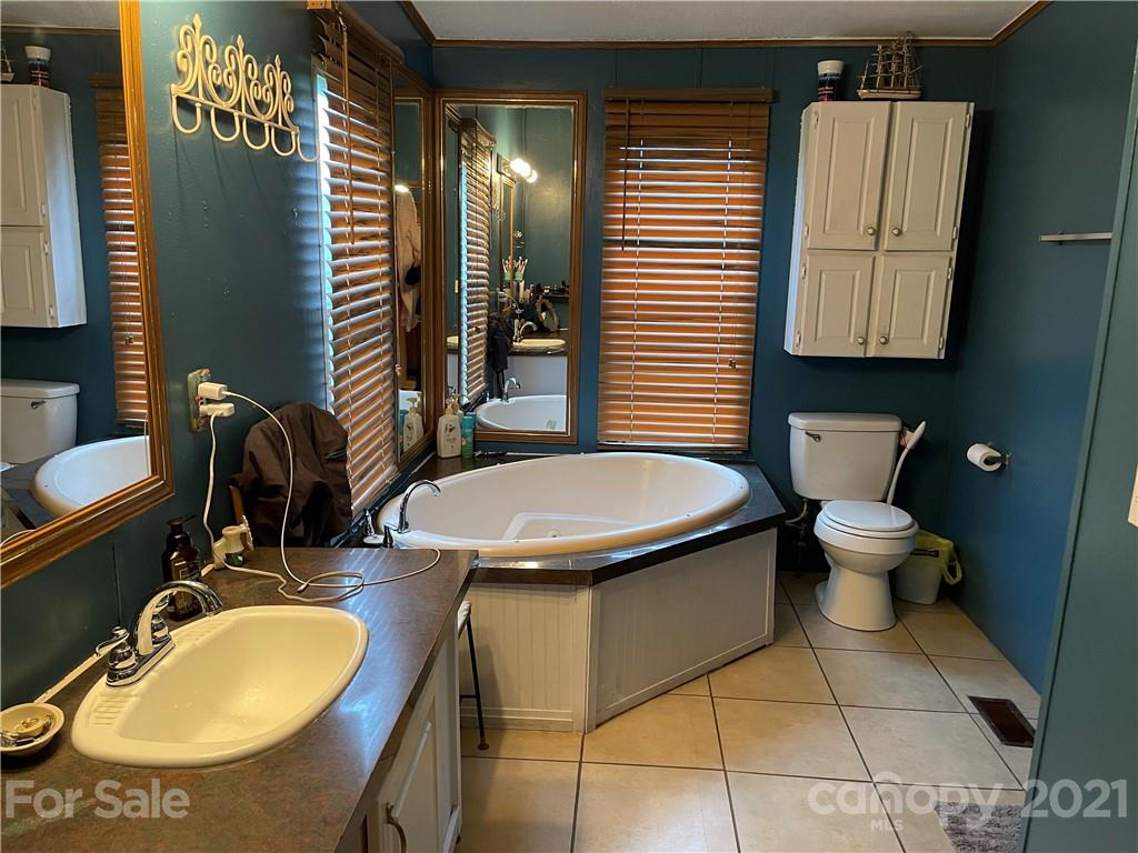141 Allen Loop Road Rutherfordton, NC 28139 - Photo 23 of 30 a bathroom with a toilet sink and mirror