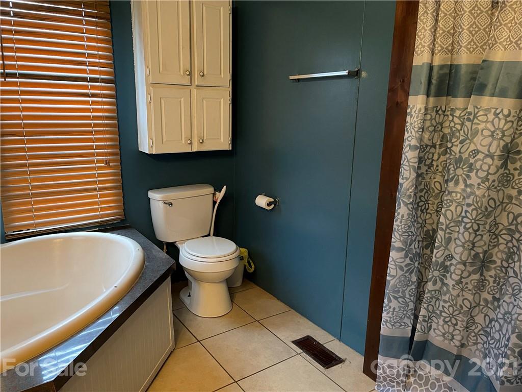 141 Allen Loop Road Rutherfordton, NC 28139 - Photo 24 of 30 a bathroom with a toilet and a shower