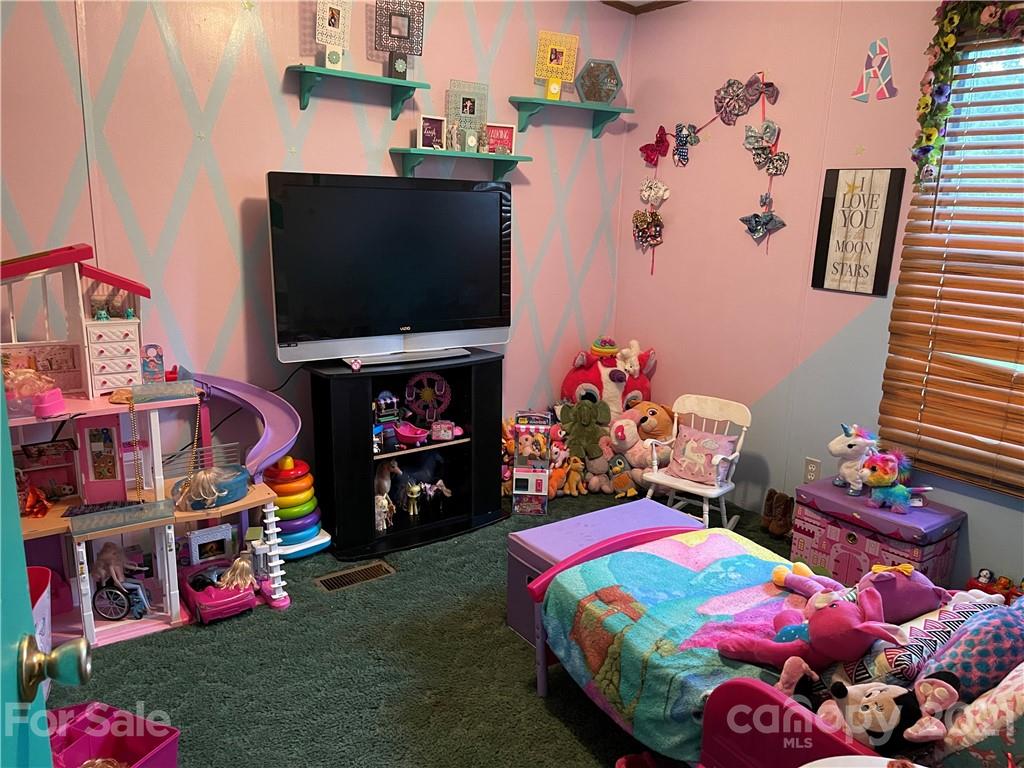 141 Allen Loop Road Rutherfordton, NC 28139 - Photo 25 of 30 a kids room with toys and a flat screen tv