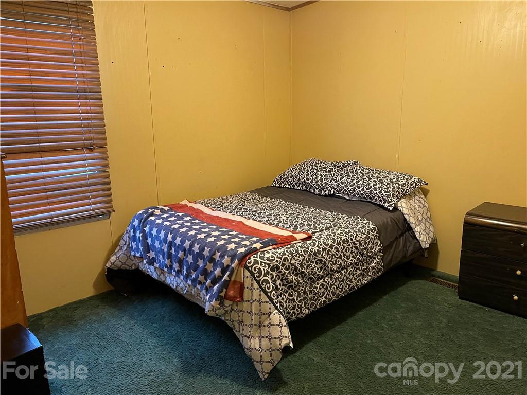 141 Allen Loop Road Rutherfordton, NC 28139 - Photo 27 of 30 a bedroom with a bed and a night stand