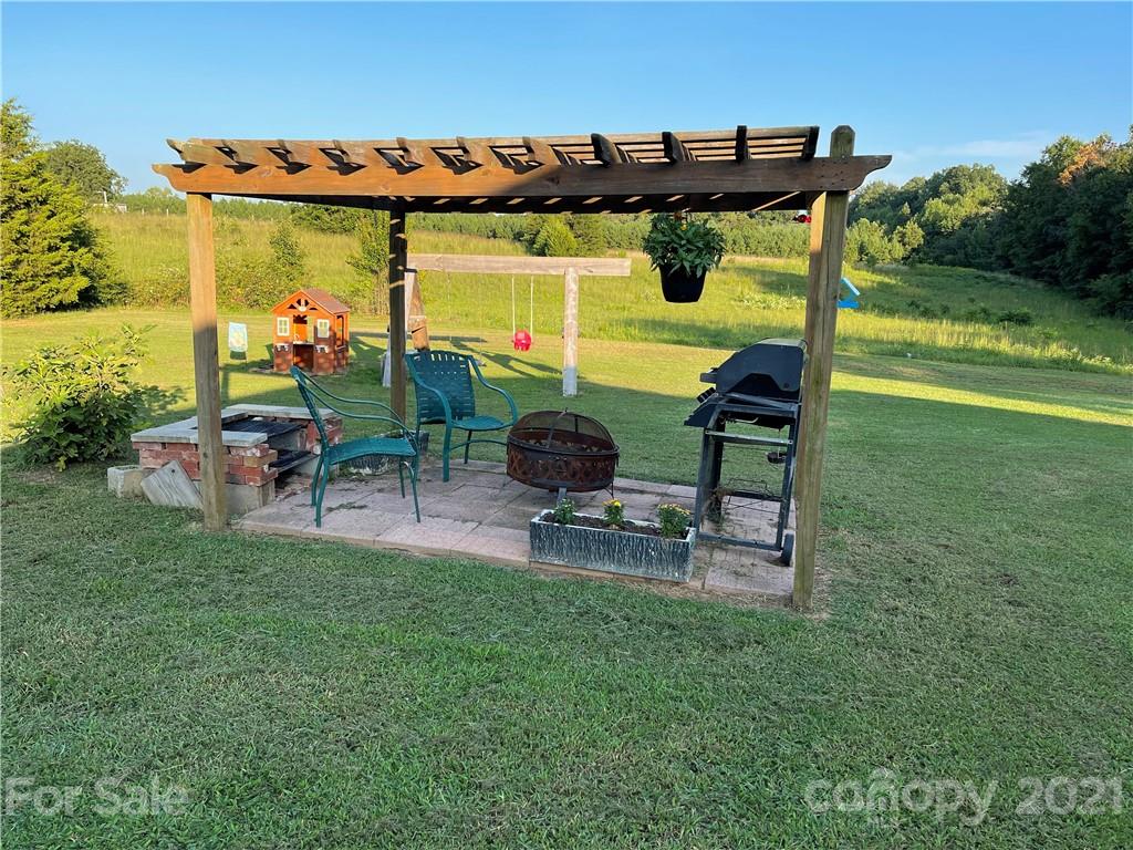 141 Allen Loop Road Rutherfordton, NC 28139 - Photo 9 of 30 a view of a patio with table and chairs and potted plants