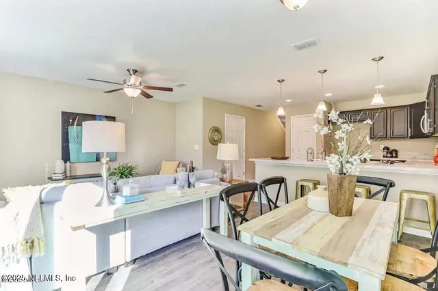 a large kitchen with kitchen island a stove a sink a dining table and chairs