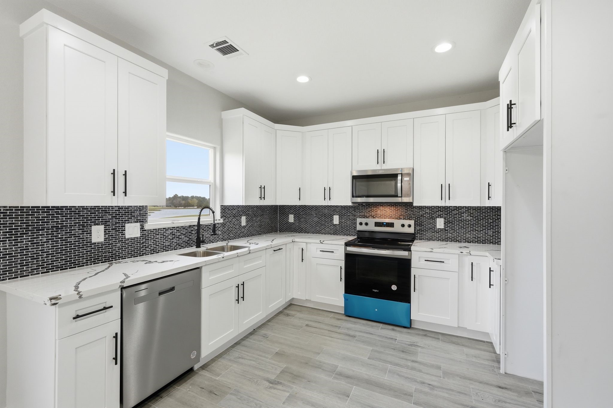 44 Meadow Lake Drive Trinity, TX 75862 - Photo 12 of 39 a kitchen with stainless steel appliances granite countertop a stove sink and cabinets