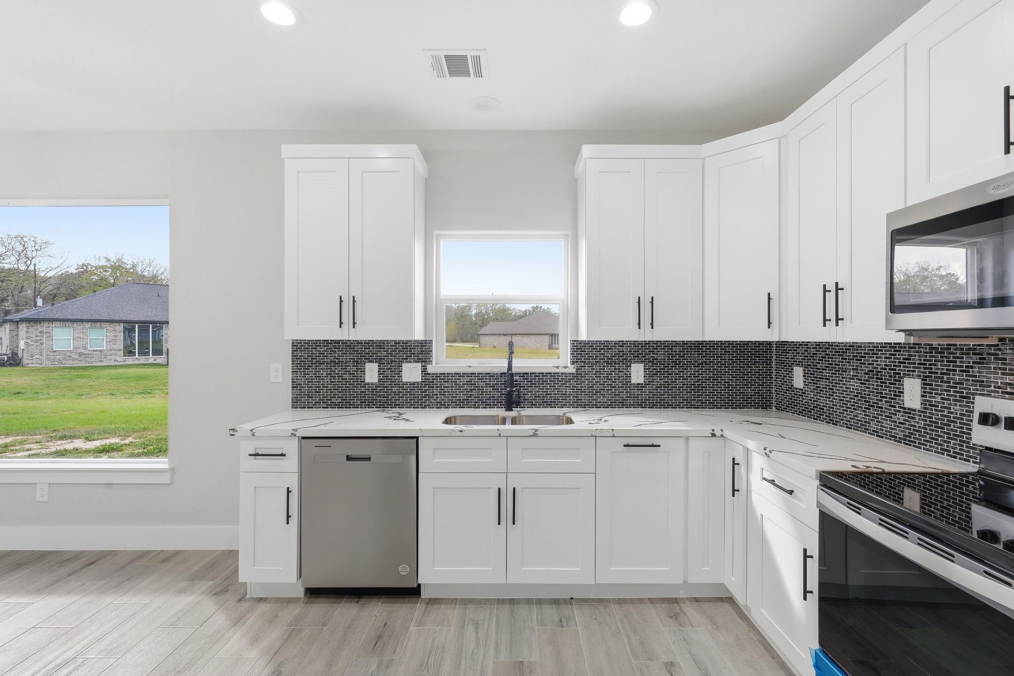 44 Meadow Lake Drive Trinity, TX 75862 - Photo 13 of 39 a kitchen with stainless steel appliances granite countertop a sink stove and cabinets