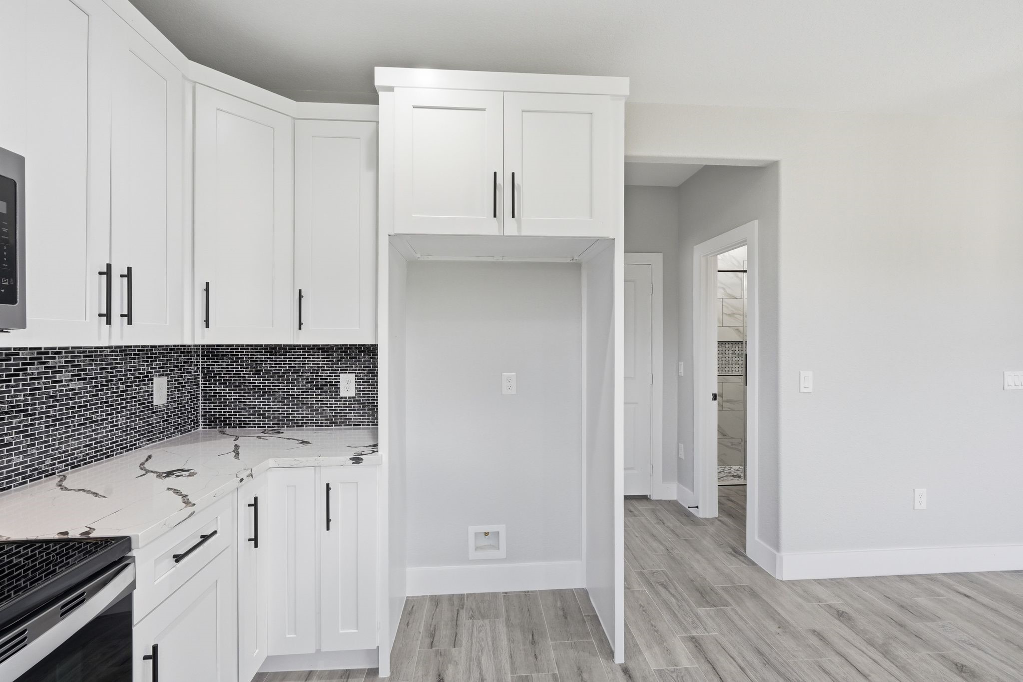 44 Meadow Lake Drive Trinity, TX 75862 - Photo 14 of 39 a kitchen with white cabinets and wooden floor