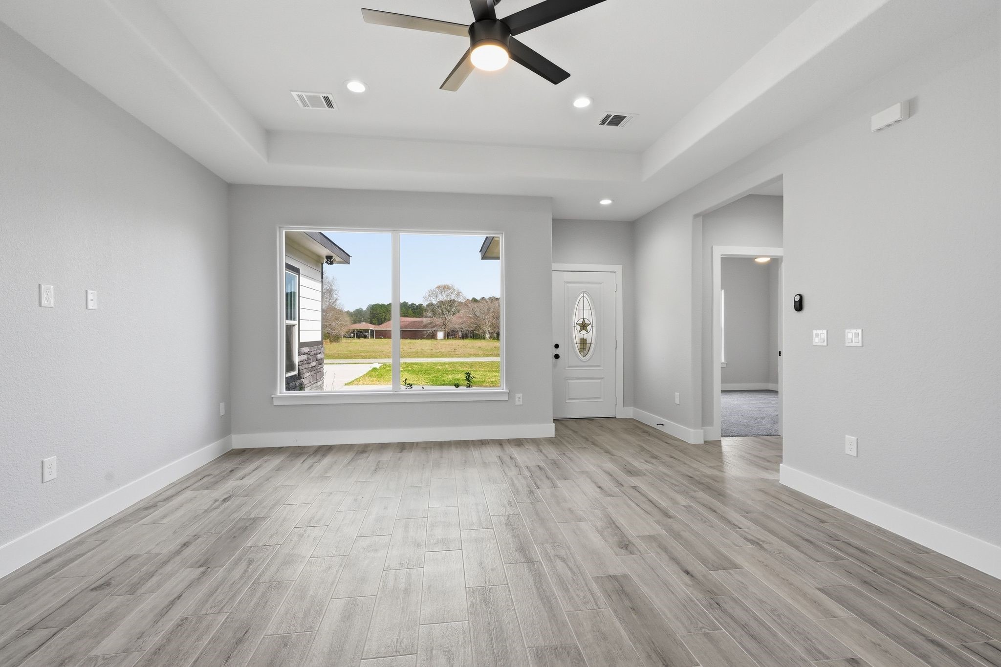 44 Meadow Lake Drive Trinity, TX 75862 - Photo 3 of 39 a view of an empty room with a window and wooden floor