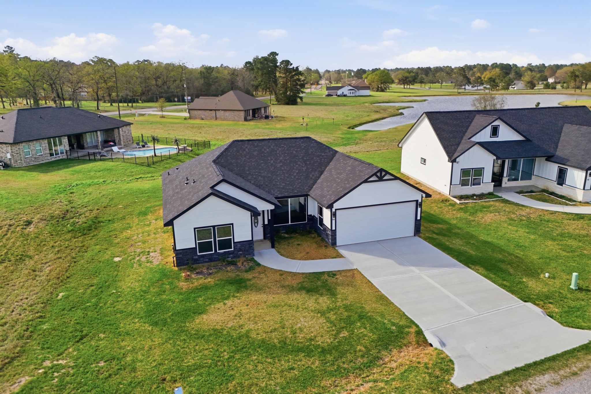 44 Meadow Lake Drive Trinity, TX 75862 - Photo 34 of 39 an aerial view of a house with swimming pool garden and outdoor seating
