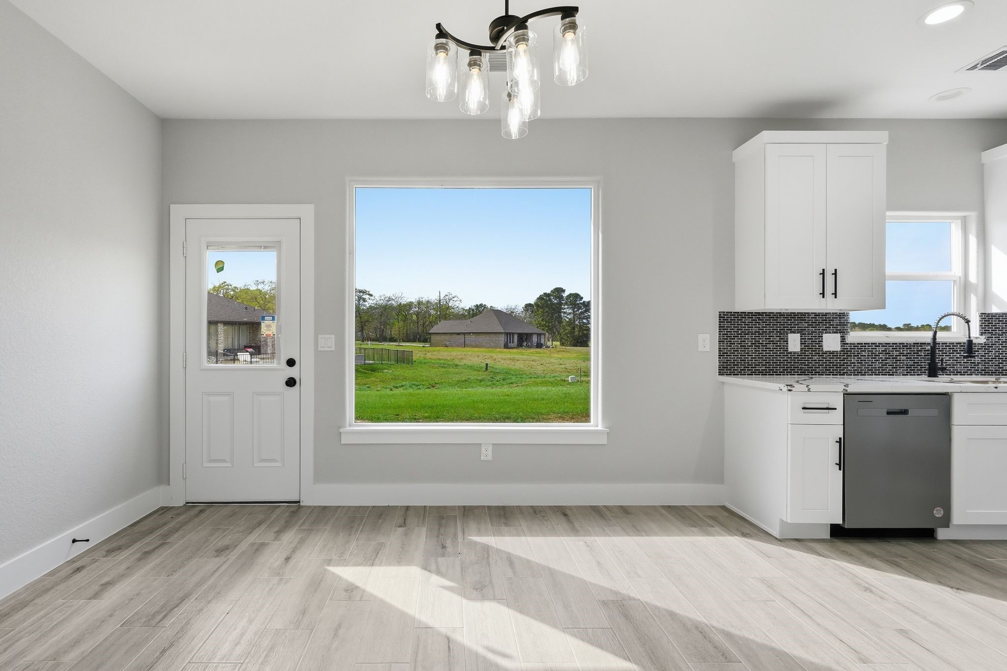 44 Meadow Lake Drive Trinity, TX 75862 - Photo 7 of 39 a view of an empty room with a window and wooden floor