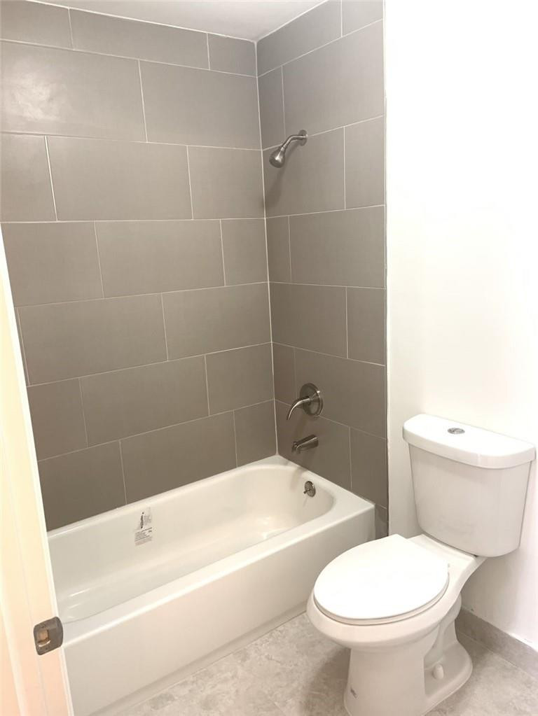 13402 Southwest 153rd Street, Unit 1901 Miami, FL 33177 - Photo 14 of 17 a white toilet sitting next to a bath tub