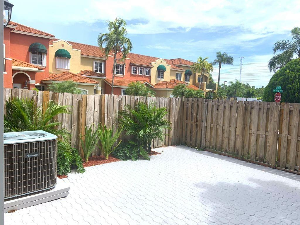 13402 Southwest 153rd Street, Unit 1901 Miami, FL 33177 - Photo 3 of 17 a view of a house with a yard and plants