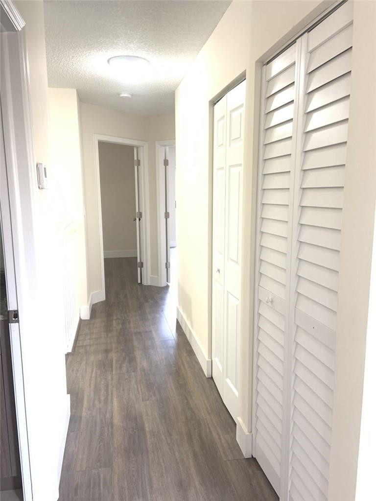 13402 Southwest 153rd Street, Unit 1901 Miami, FL 33177 - Photo 6 of 17 a view of hallway with wooden floor