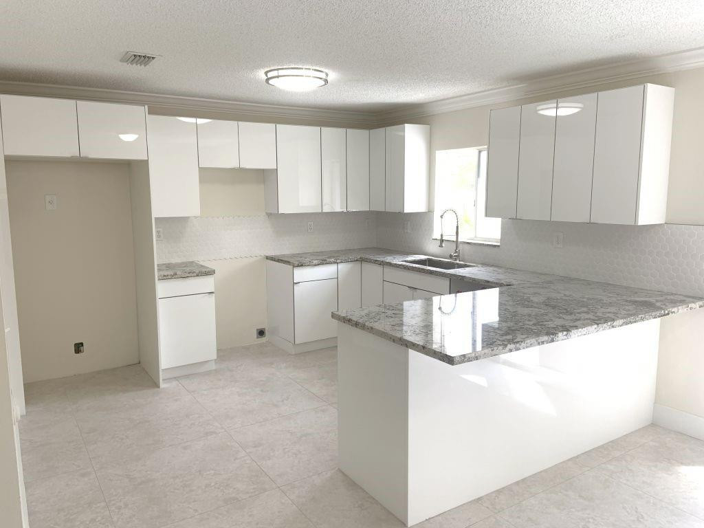 13402 Southwest 153rd Street, Unit 1901 Miami, FL 33177 - Photo 7 of 17 a kitchen with granite countertop a stove a sink and a refrigerator