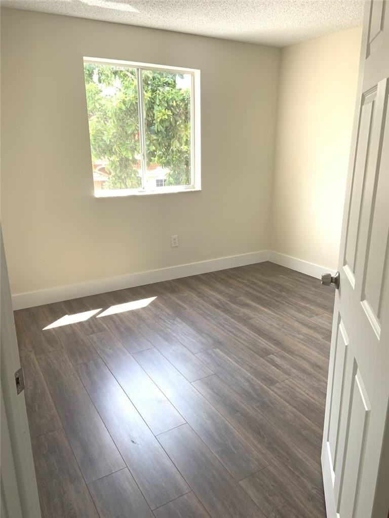 13402 Southwest 153rd Street, Unit 1901 Miami, FL 33177 - Photo 10 of 17 an empty room with wooden floor and windows