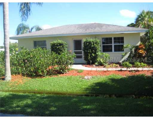 711 Coconut Road Venice, FL 34293 - Photo 1 of 1 a front view of a house with a yard and outdoor seating