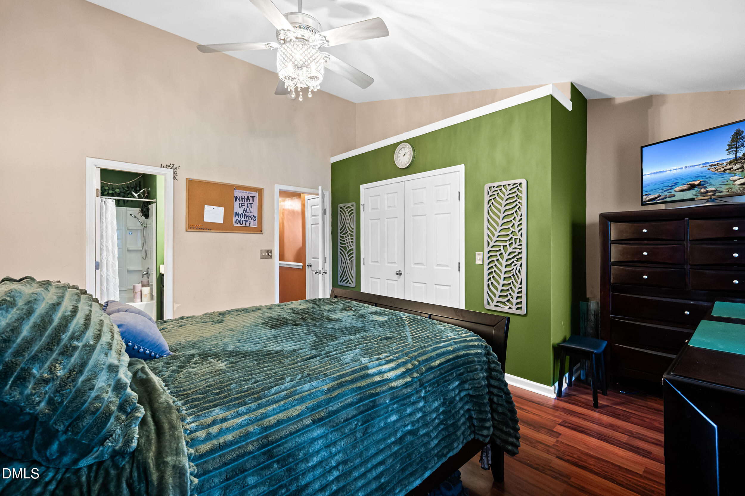 2944 Casona Way Raleigh, NC 27616 - Photo 14 of 24 a bedroom with a bed and a flat tv screen on dresser