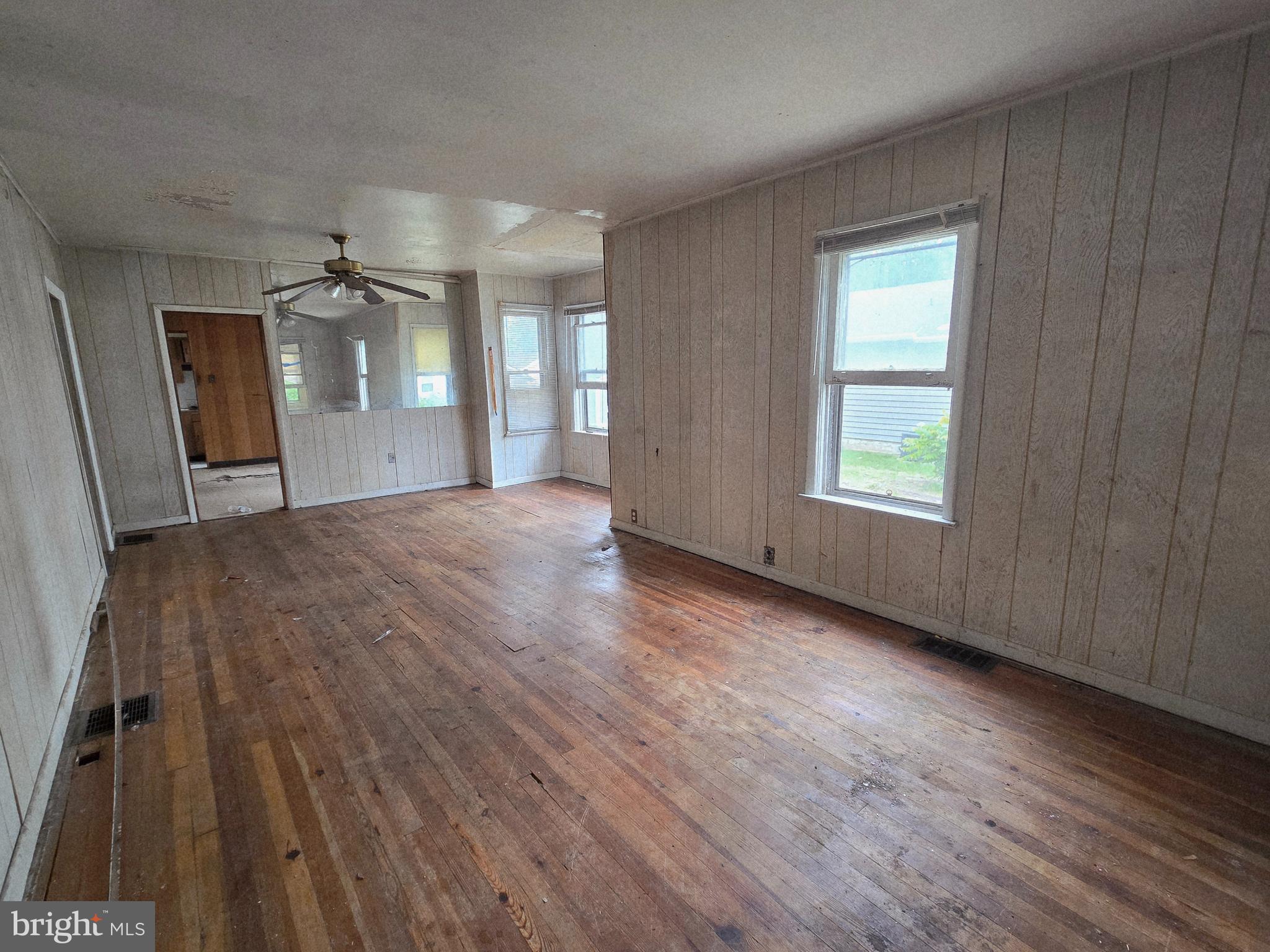 36 Atlantic Avenue Clementon, NJ 08021 - Photo 11 of 19 wooden floor in an empty room with a window