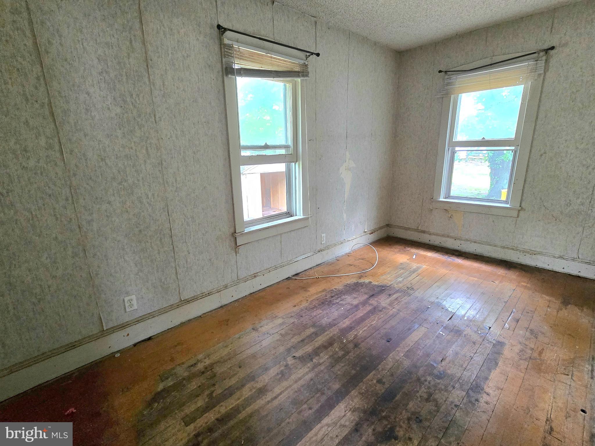 36 Atlantic Avenue Clementon, NJ 08021 - Photo 14 of 19 an empty room with wooden floor and windows