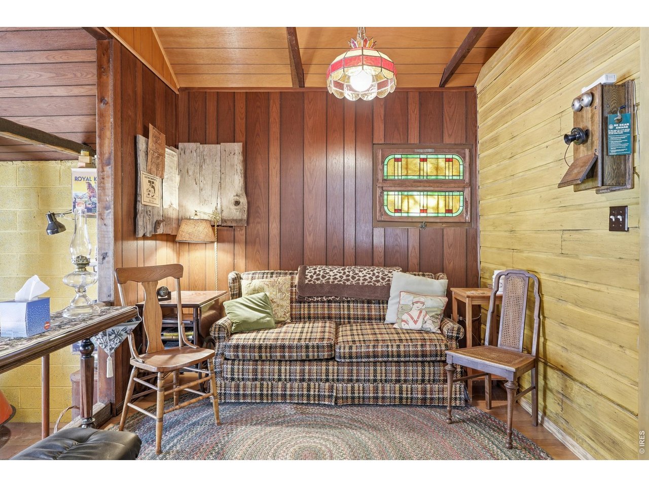 2476 Riverside Drive Lyons, CO 80540 - Photo 7 of 42 a bedroom with a bed and a chandelier