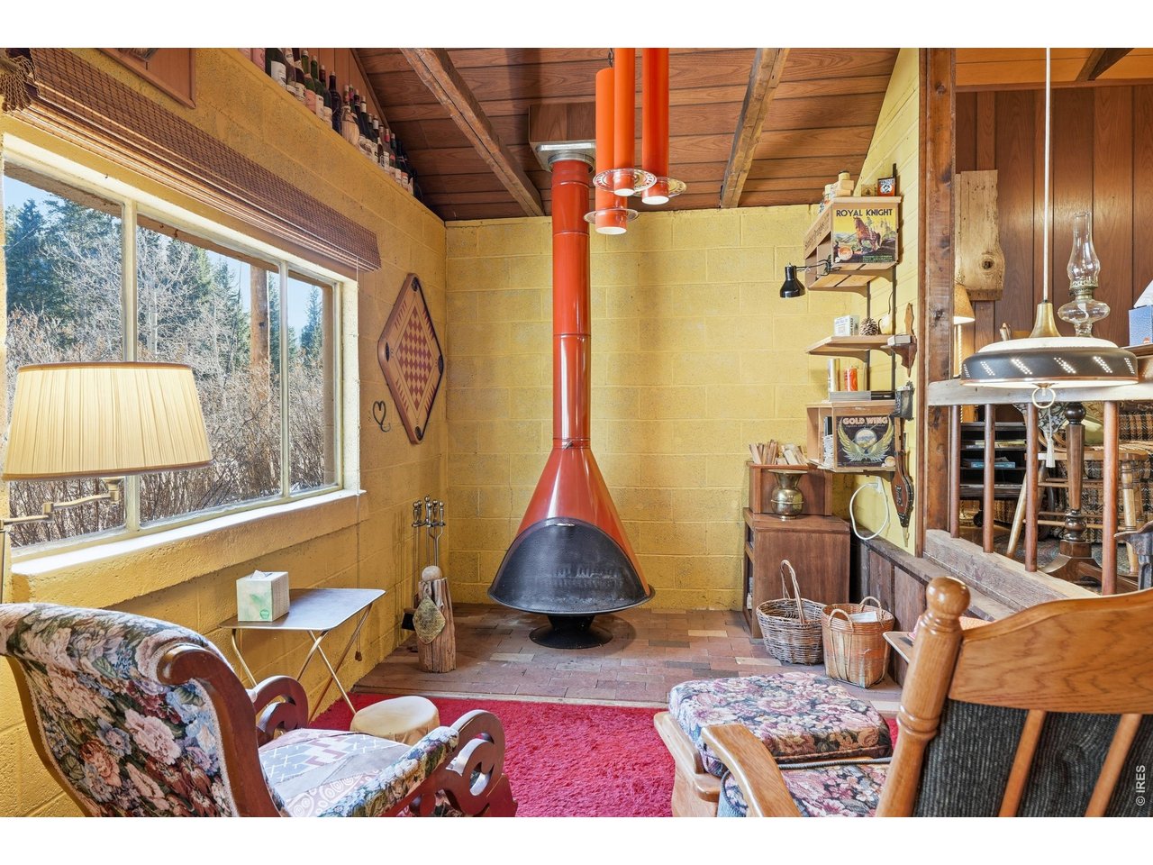 2476 Riverside Drive Lyons, CO 80540 - Photo 8 of 42 a living room with couches rug and a large window with garden view