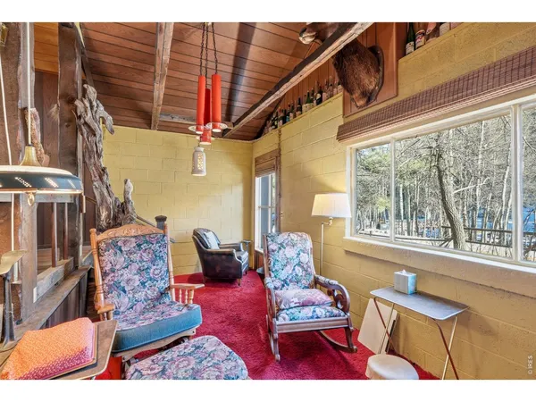 a bedroom with a bed table and a window