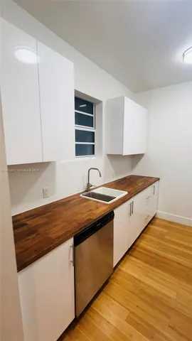 a kitchen with granite countertop a stove and a microwave