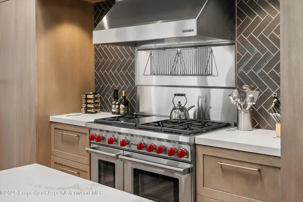 a stove top oven sitting inside of a kitchen