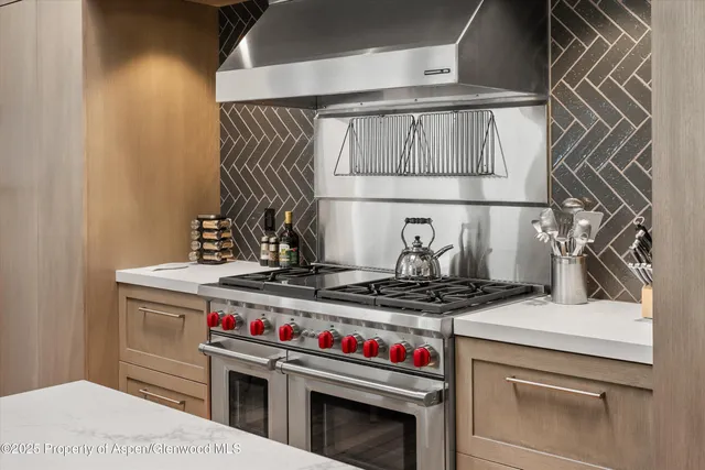 a stove top oven sitting inside of a kitchen