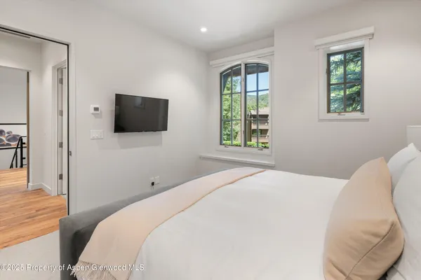 a bedroom with a bed and a flat screen tv