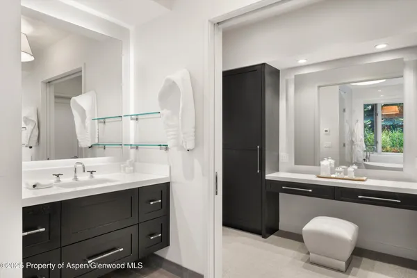 a bathroom with a double vanity sink and a mirror