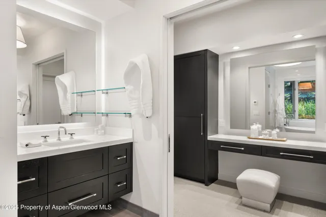 a bathroom with a double vanity sink and a mirror