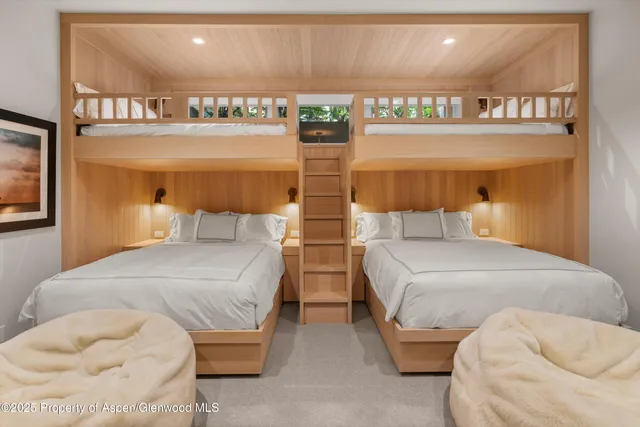 a bedroom with two beds and a night stand