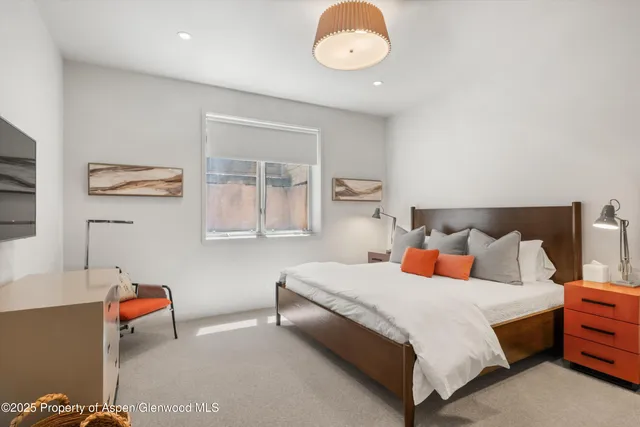 a bedroom with bed and window