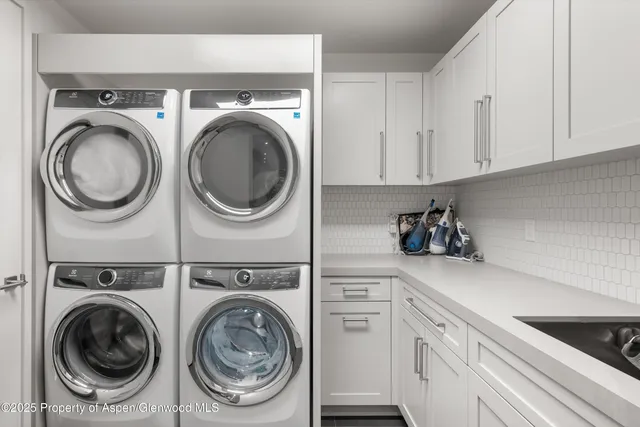 a utility room with sink dryer and washer